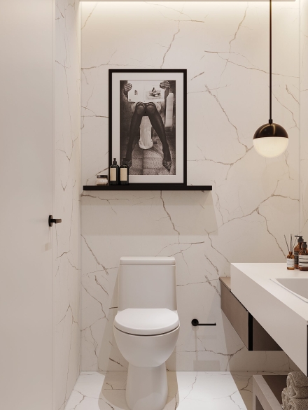 Small powder room cladded in marble porcelain tiles and artwork on the wall by Studium Dekor.
