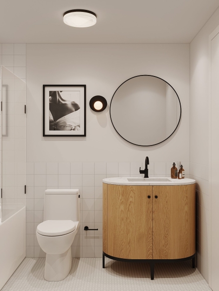Modern small bathroom with round mirror, oak vanity, white fixtures, artistic black and white photo, and hex tile floor by Studium Dekor.