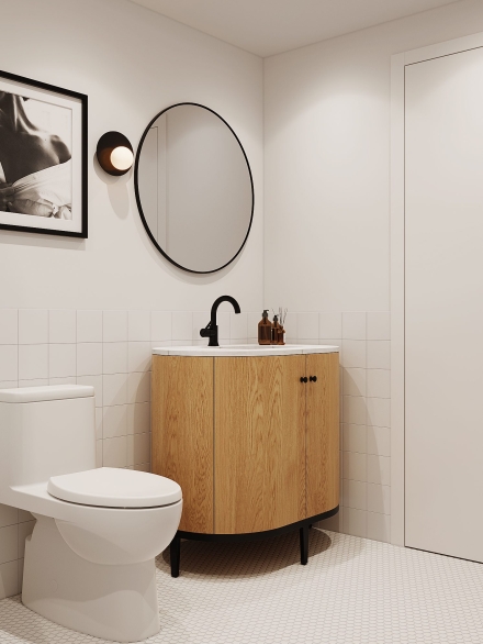 Modern small bathroom with a round mirror, black accents, oak vanity, and a black and white photograph by Studium Dekor.
