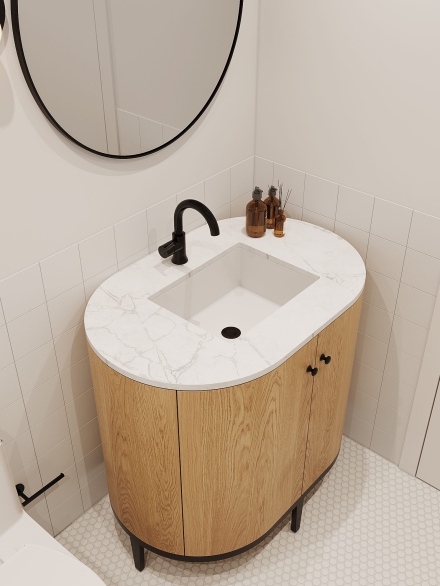 Chic small bathroom with round mirror, marble-top oak vanity, and hexagonal tile floor by Studium Dekor.